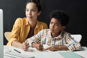 Foster mom helping foster child with their homework