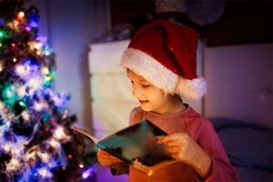 Foster child reading a Christmas book